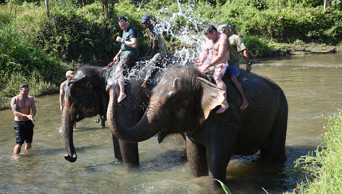 Riders from UK enjoying elephant bathing in Chitwan National Park.